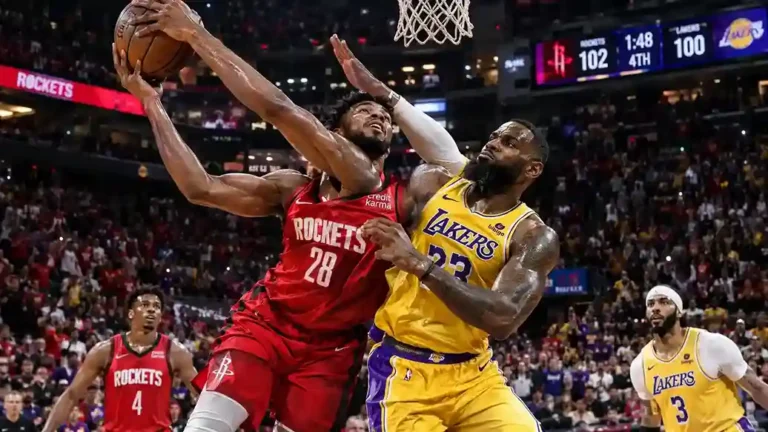 Alperen Sengun Rockets #28 battles LeBron James Lakers #23 for a layup in intense NBA matchup, Rockets lead 102-100 late in 4th quarter