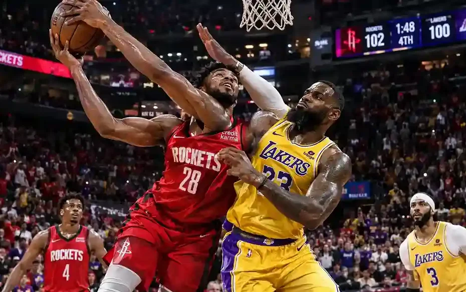 Alperen Sengun Rockets #28 battles LeBron James Lakers #23 for a layup in intense NBA matchup, Rockets lead 102-100 late in 4th quarter